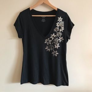 Express black v-neck T-shirt with silver floral sequin detail. Size large.